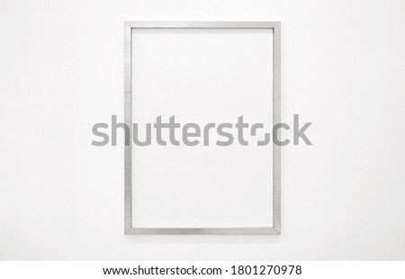 Simple silver frame on white wall