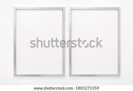 Simple silver frame on white wall