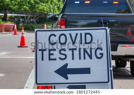 Covid testing sign on a barricade in the street in Florida. Royalty-Free Stock Photo #1801272445