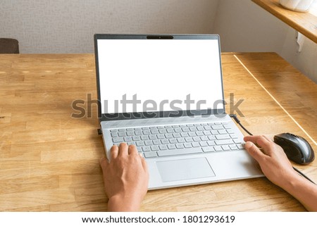 Mockup image of woman's hands using and typing on laptop with blank white desktop screen