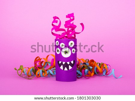 Collection of toilet tube monsters on purple background for Halloween decor. Creative idea of handwork