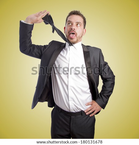 Business man pulling out his tie over orange gradient background