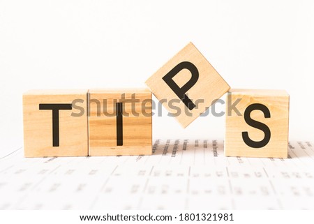 Word tips. Wooden small cubes with letters isolated on white background with copy space available.Business Concept image.