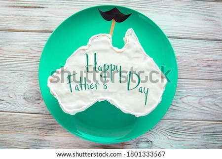 vanilla cream cake in a shape of the Australia message greeting card, with mustache, father's day gift	
