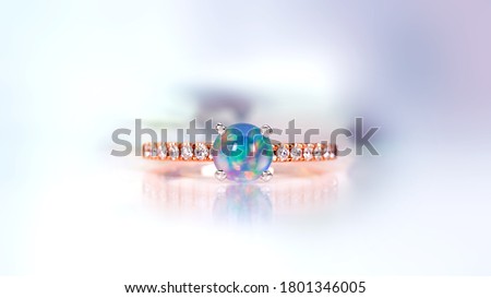Opal And Diamond Ring on abstract color background