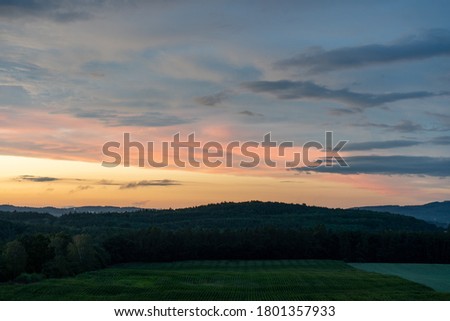 
sunset on a field in the countryside in the czech republic in the sky there are clouds