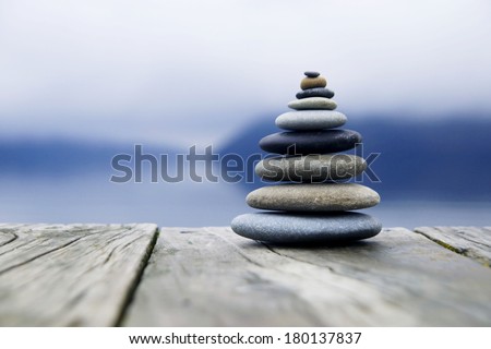 Zen Balancing Rocks o a Deck, New Zealand Royalty-Free Stock Photo #180137837