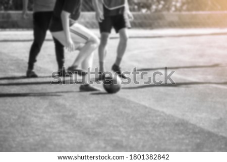 Blurry picture of black and white sport background. Soccer player control and shoot ball to goal with goalkeeper. Soccer players fighting with goalkeeper.