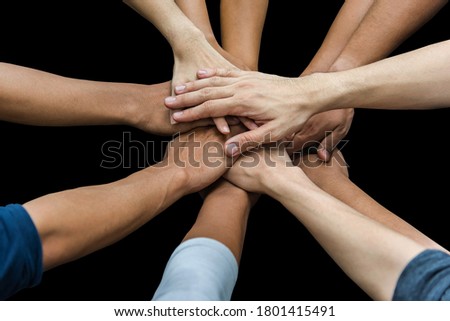 Image of group of overlapping hands against black background
 Royalty-Free Stock Photo #1801415491