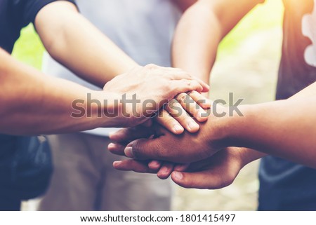 Solidarity unite people hands together community teamwork. Hands of spirit team working together outdoor. Unity strong handshake with people or agreement of feeling or happy diverse education action Royalty-Free Stock Photo #1801415497