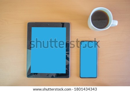 tablet and cell phone mockup with editable screens. on desk with coffee