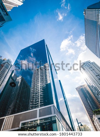 Ultra modern skyscrapers in Fort Bonifacio. Reflection of buildings on a glassy office highrise. Shot in Metro Manila, Philippines. Royalty-Free Stock Photo #1801443733