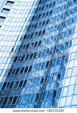 Modern skyscraper blue windows  glass wall with reflections