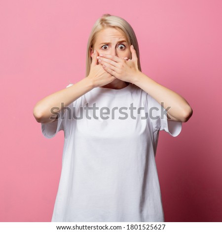 Blonde woman in white moch-up tshirt on pink background