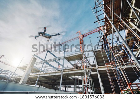 Drone over construction site. video surveillance or industrial inspection	