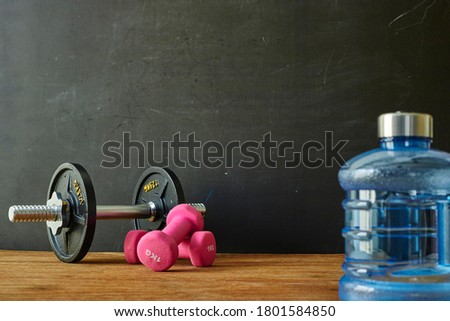 A studio photo of gym dumbells