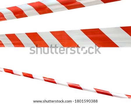 Red and white lines of barrier tape prohibit passage. Barrier tape on white isolate. Barrier that prohibits traffic. Warning tape. Danger unsafe area warning do not enter. Concept of no entry