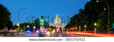 Panorama of The United States Capitol building in Washington DC with street and traffic light, long exposure, night cityscape 