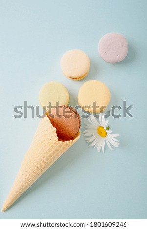 Several colorful macaroon cakes on a colored background