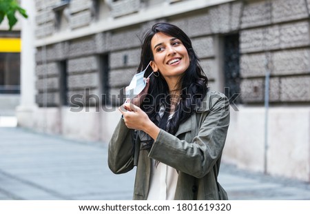 Coronavirus is over we won concept. Woman holding mask. We won sign outdoor in the sunshine freedom. We are safe. Coronavirus ended. We won. No more quarantine. Breathe deep. Take off the mask. Cure. Royalty-Free Stock Photo #1801619320