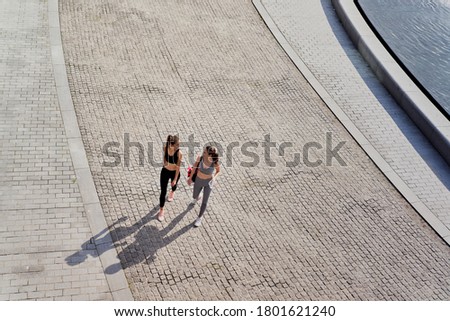 Top view of two happy women going in training                               