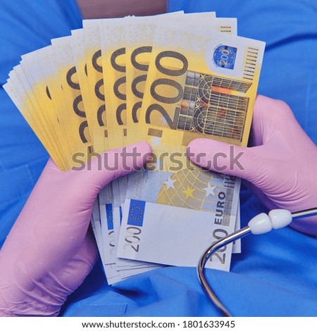 The doctor holds cash notes in euros in his hands. A female nurse with money to buy medicine for coronavirus