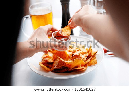 Nachos with cheese and tomato dip. Mexican cuisine. An appetizing snack. Suggestion to serve the dish. Culinary photography.
