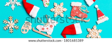 Top view Banner of Christmas decorations and Santa hats on blue background. Happy holiday concept.