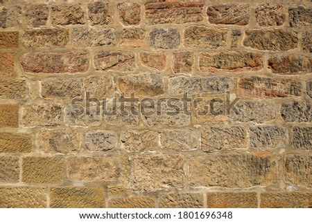 historical yellowish sandstone wall as background Royalty-Free Stock Photo #1801696348
