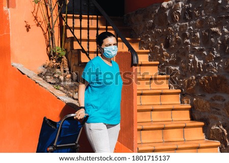 shopping muller with surgical protective mask in the new normal of coronavirus Covid-19. social distance