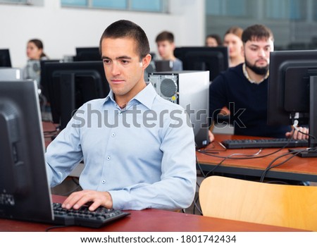 Computer lessons for adults in classroom. High quality photo