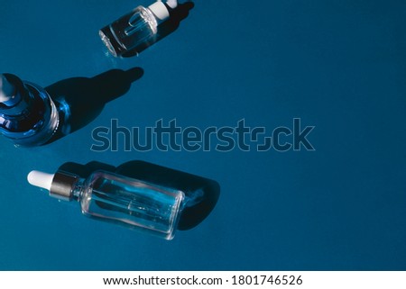 Glass Bottle with fluid collagen and hyaluronic acid, hydration skin. Top flatlay view copyspace. Natural background