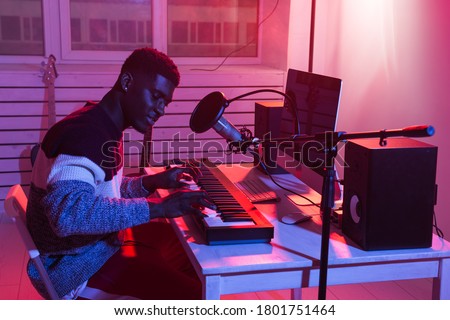 Music production concept - Male sound producer working in home recording studio. Royalty-Free Stock Photo #1801751464
