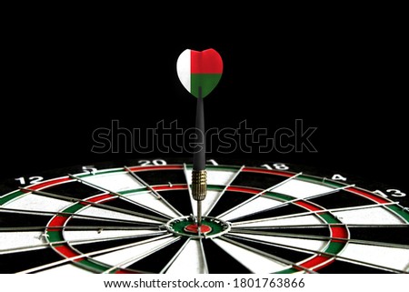 The flag of Madagascar is featured on the dart board game, the concept of achieving goals.