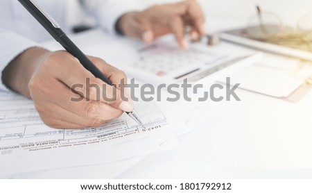 Accountant working with tax forms.Tax deduction planning concept. 