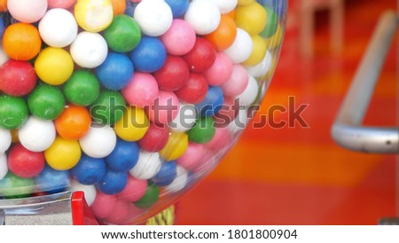 Colorful gumballs in classic vending machine, USA. Multi colored buble gums, coin operated retro dispenser. Chewing gum candies as symbol of childhood and summertime. Mixed sweets in vintage automate. Royalty-Free Stock Photo #1801800904