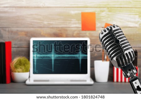 Classic microphone in the studio recording creating the sound effect with a laptop
