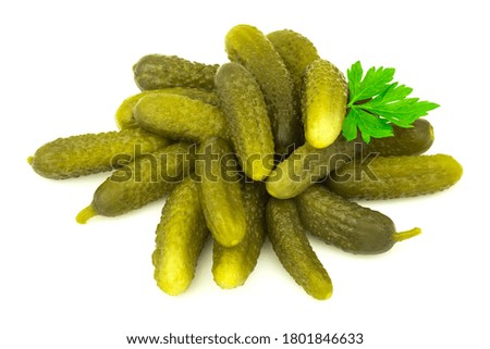 Salted marinated pickled cucumbers with fresh parsley isolated on white background