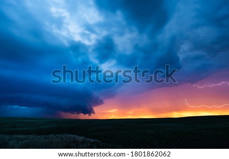 Supercell Thunderstorm With Lightning At Sunset