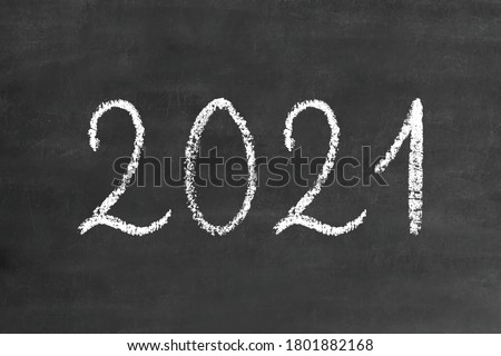 2021 numbers in handwritten thin stroke white chalk brush font, stock vector illustration clip art design element on grunge black chalkboard background for calendar, poster, flyer, card
