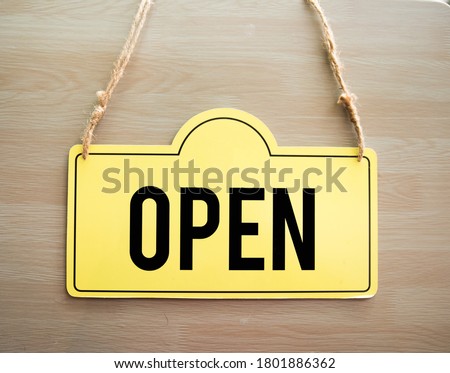 open storefront sign on wooden background