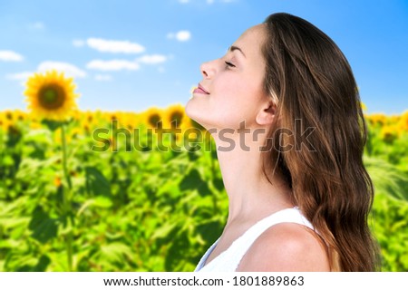 Happy young woman with perfect skin on outdoor background