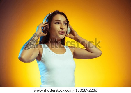Young woman isolated on yellow background. Stylish, trendy look
