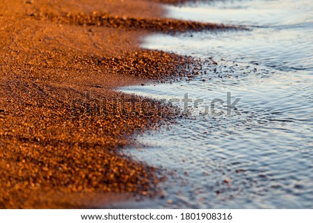 Shining golden sand and water
