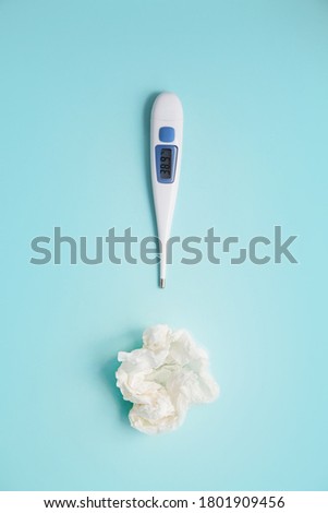 thermometer and crumpled handkerchiefs on a blue background