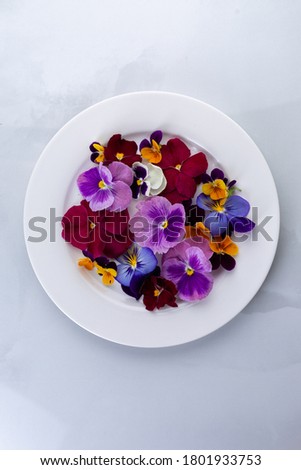 Edible flowers on a plate Royalty-Free Stock Photo #1801933753