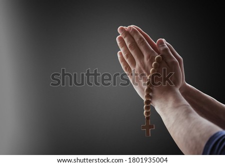 Praying hands of male with rosary beads Royalty-Free Stock Photo #1801935004