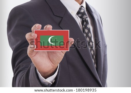 Businessman in suit holding a business card with Maldives Flag 