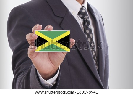 Businessman in suit holding a business card with Jamaica Flag 