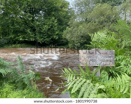An ironic image of a raging river and sign 